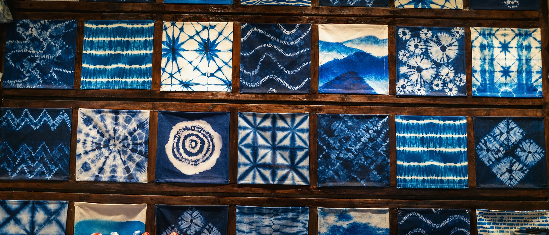 Wall of indigo shibori-dyed fabric squares
