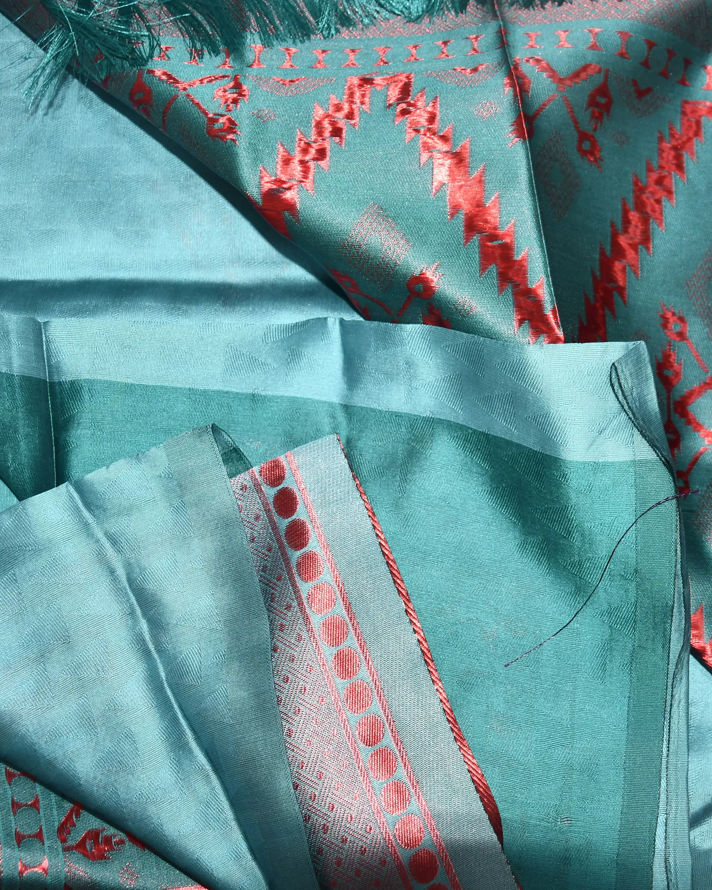 Turquoise silk with a woven temple border